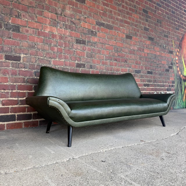 Sculptural Mid-Century Modern Sofa in Green Upholstery Striking sculptural mid-century modern sofa featuring a dramatic...