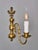Wall lamp made of cast brass decorated with an eagle and a fish on top. The lamp was made in the mid-20th century. Now the...