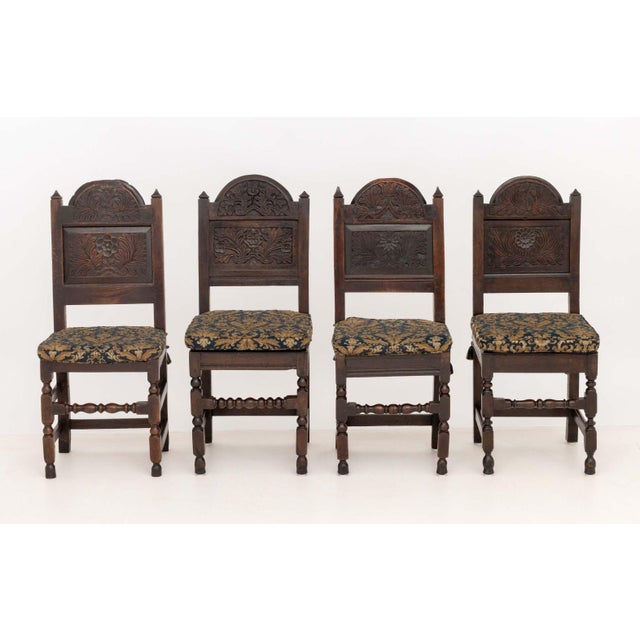 Set of Eight Jacobean Carved Oak Dining Chairs, late 17th century with later modifications, various floral motif carved...
