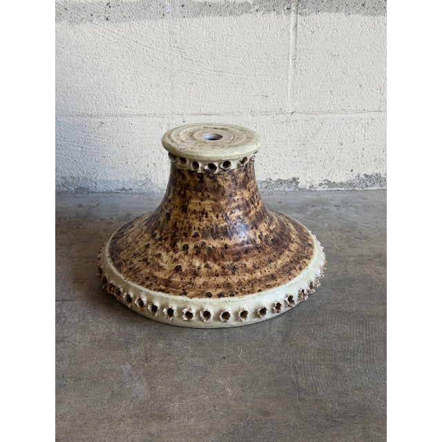 This charming ceramic lamp shade features a textured brown and beige glazed pottery finish with unique pierced hole...
