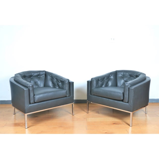 Gorgeous pair of leather tufted reupholstered lounge chairs with steel bases.. Excellent comfortable condition.. Both are...