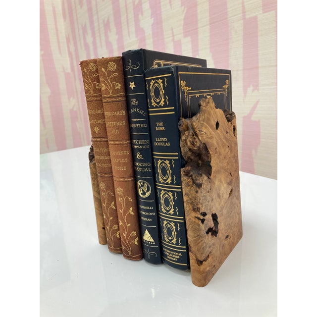 An elegant and organic pair of burl bookends with wonderful wood graining and natural edges. Brass stands securely...