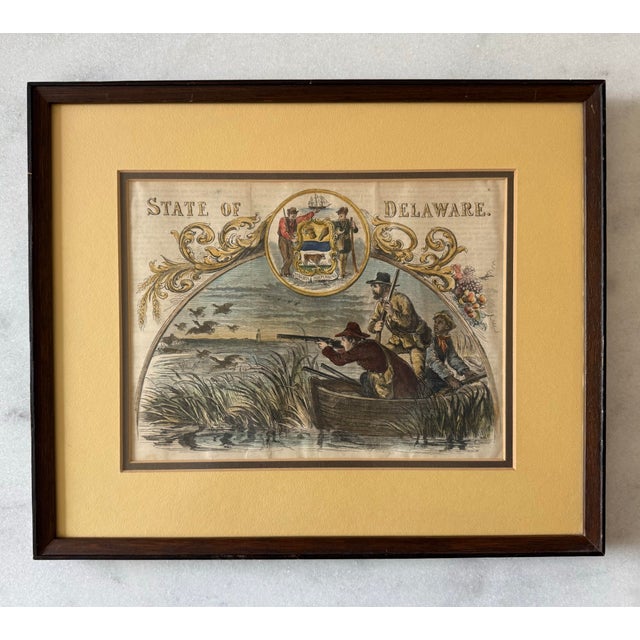 Framed 19th century hand colored lithograph titled "State of Delaware" featuring a central scene of duck hunters in a boat...