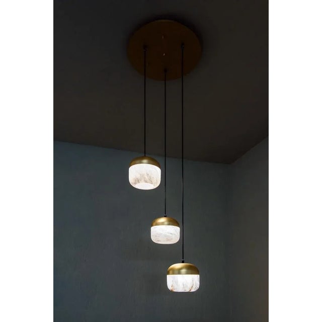 Copper 3 pendant lamp by united alabaster dimensions: d 60 x h 180 cm materials: alabaster, copper (satin gold finish)...