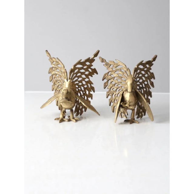 This striking pair of mid-century brass bird figures captures a sense of movement and sculptural detail. Designed as...