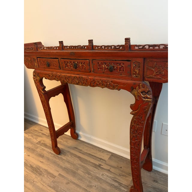 This item is a traditional, handmade Chinese red lacquer altar table, featuring intricate carvings and a distressed...