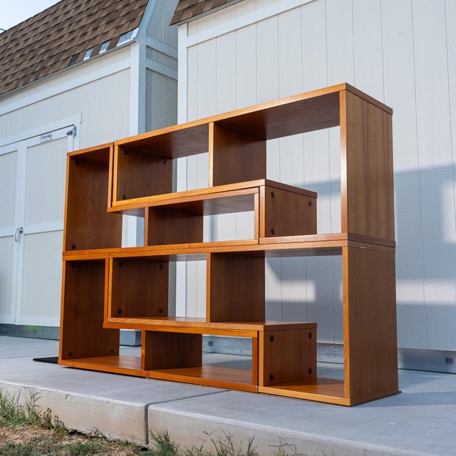 Vintage Scandinavian teak modular shelving system consisting of four individual interlocking pieces. Each piece features...