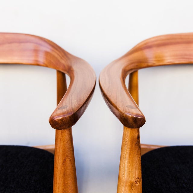 A rare set of four low-back elmwood dining or accent chairs by Illum Wikkelsø, produced in Denmark by Niels Eilersen c....