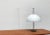 Rare Mid Century table lamp. A minimalist design. The large shade shows a simple hemispherical shape and is finished in...