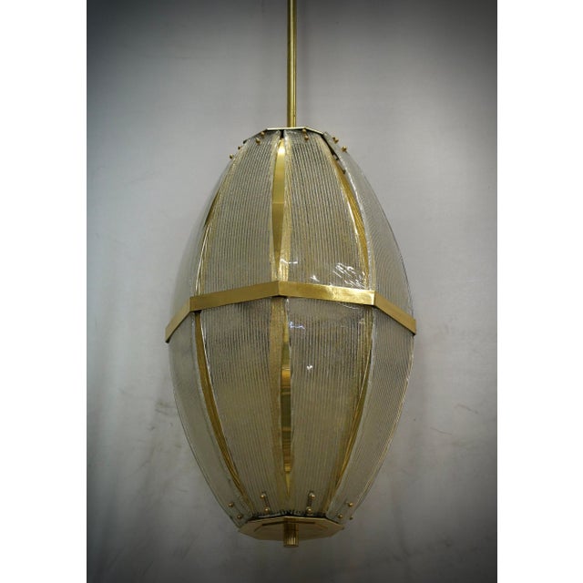 Special and very original lantern in brass and Murano glass, unique design enriched by a particular glass with sandblasted...