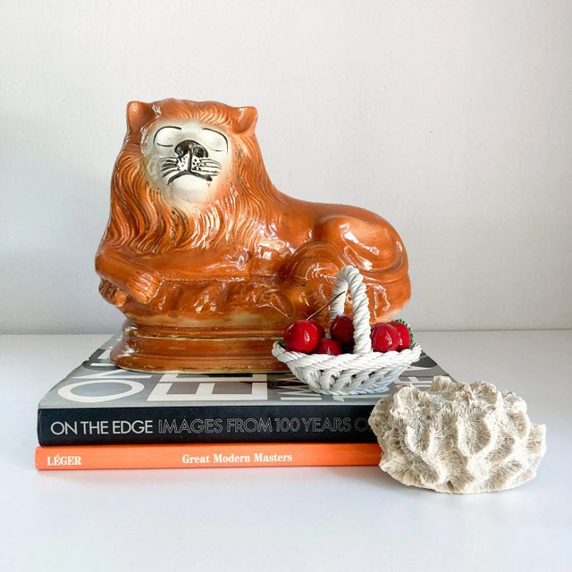 This vintage ceramic recumbent 'sleeping' Staffordshire lion figurine noble, enchanting and stately all at once. Weighing...