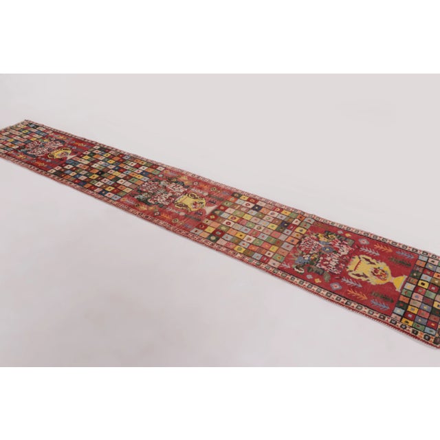 Hand-knotted in wool and originating circa 1950-1959 from Afghanistan, this 2x12 vintage Gabbeh extra-long runner joins...