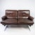 Two seater sofa upholstered with patinated brown leather and frame in metal, designed by Arne Norell from the 1970s. The...