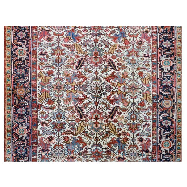 A beautiful early 20th century Persian Heriz rug a fantastic mirrored floral pattern with large-scale leaves and flowers,...