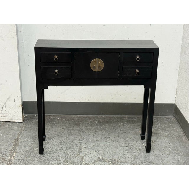 Design Plus Gallery presents an Asian Black Console Cabinet. The console features four drawers and a two-door center...