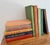 Set of 10 international cookbooks in late-summer harvest inspired colors of oranges, greens, browns, and pinks. All...