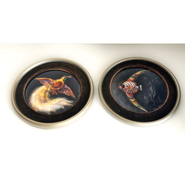Pair of antique enamel medallion-shaped paintings depicting a bird and a multicolored fish. Signed by the Swiss enamel...