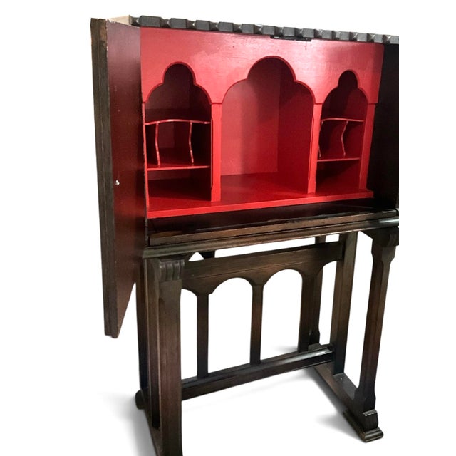 An exceptional Spanish Revival writing cabinet that blends Old World craftsmanship with dramatic architectural styling....