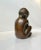 Stylized and mythological small bronze sculpture depicting a baby boy embracing a fish. Designed and studio cast by german...