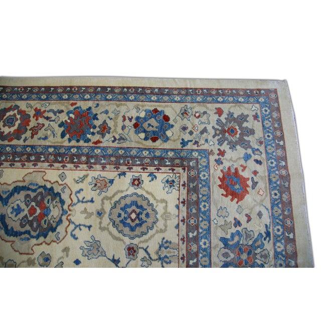 This modern finewoven Turkish Oushak rug is a stunning piece of art that has been handwoven using traditional techniques...