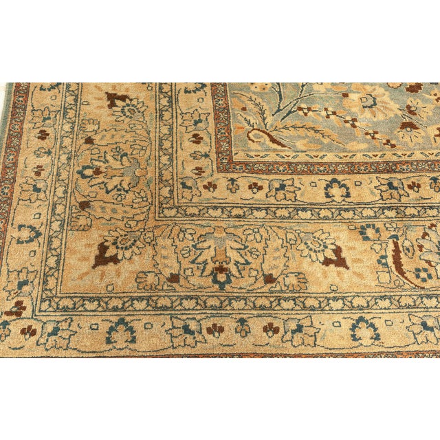 An early 20th century Khorassan antique rug, the blue field with an overall design of blossoming trees and shrubs,...