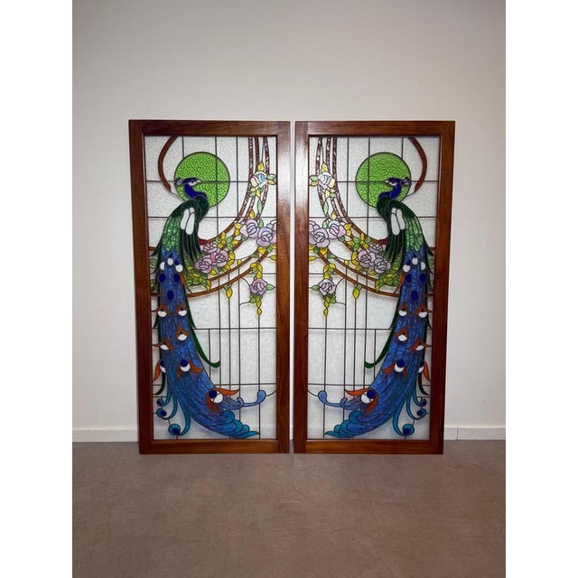 An exceptional vintage stained glass peacock panel, beautifully handcrafted with vibrant coloured glass and framed in...