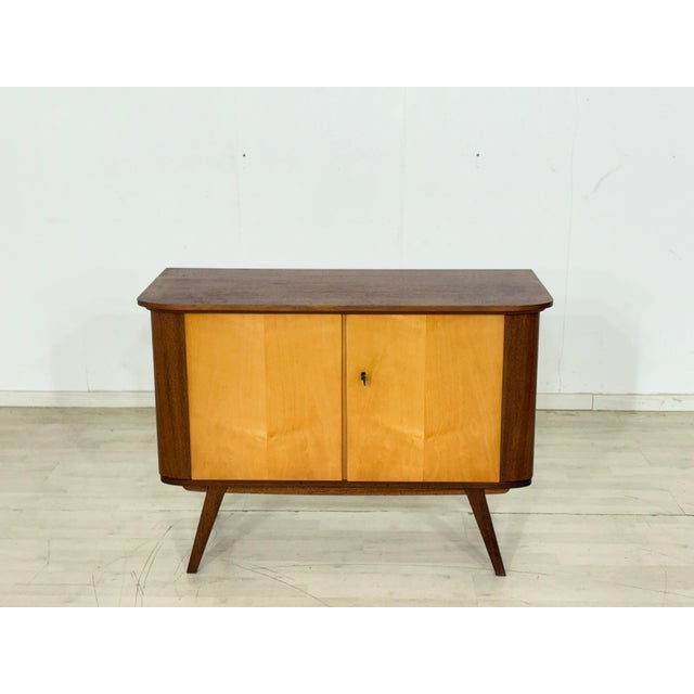 Very beautiful mid-century modern chest of drawers from the 1960s. The piece impresses with its clean lines, elegant wood...