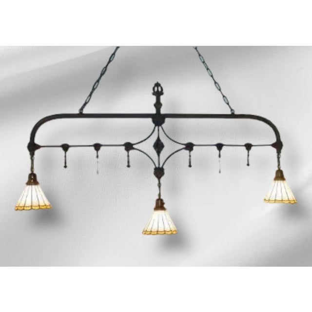 This antique chandelier is full of unique and charming embellishments! Crafted from a very old bedframe, This light has...