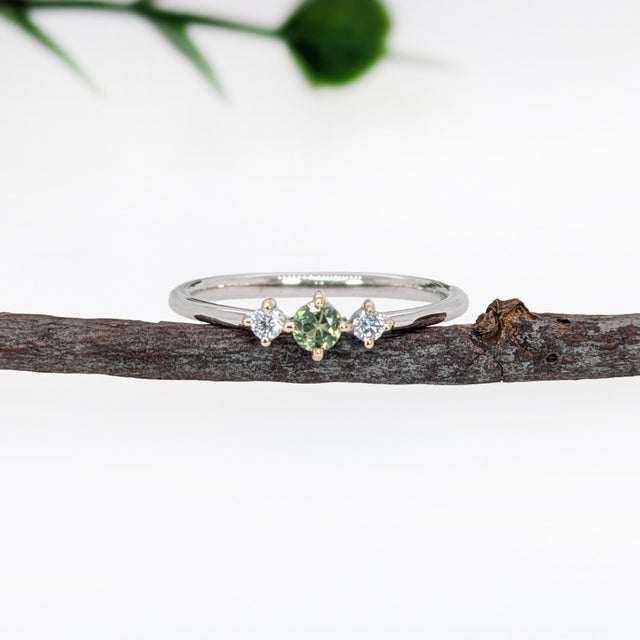 This beautiful ring features an alexandrite in 14k white Gold and two diamond accents. A dainty ring design perfect for an...