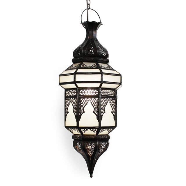Moroccan vintage pendant light featuring hand-cut frosted glass panels encased within a richly dark toned bronze metal...