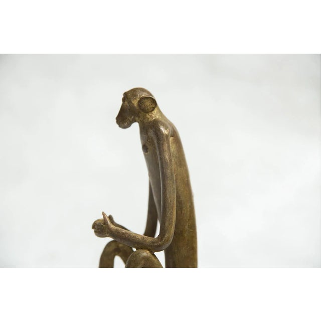 :: Vintage African sculpture of monkey with hands touching, made approximately 40-70 years ago. Each figure in this...