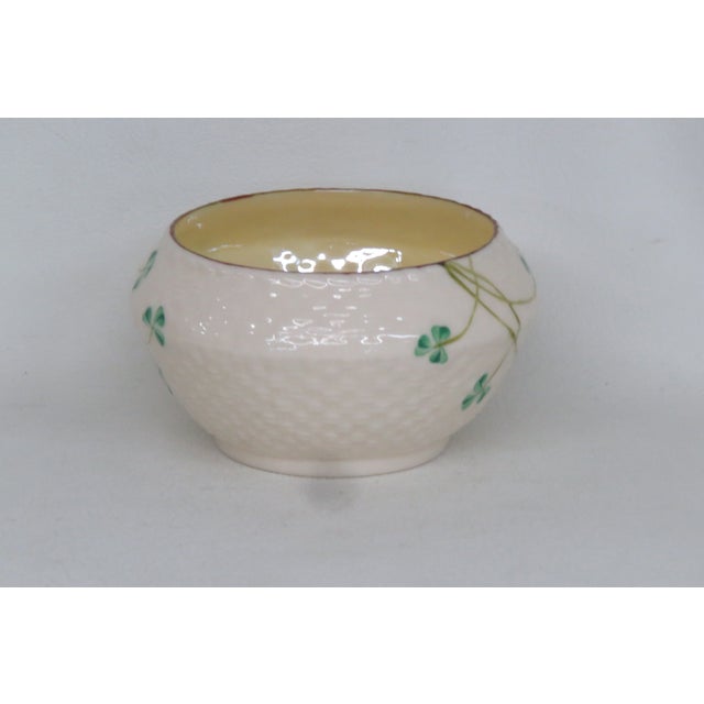 This lovely Sugar Bowl is made out of porcelain. This Sugar Bowl is stamped as being made by Belleek in Ireland. This...
