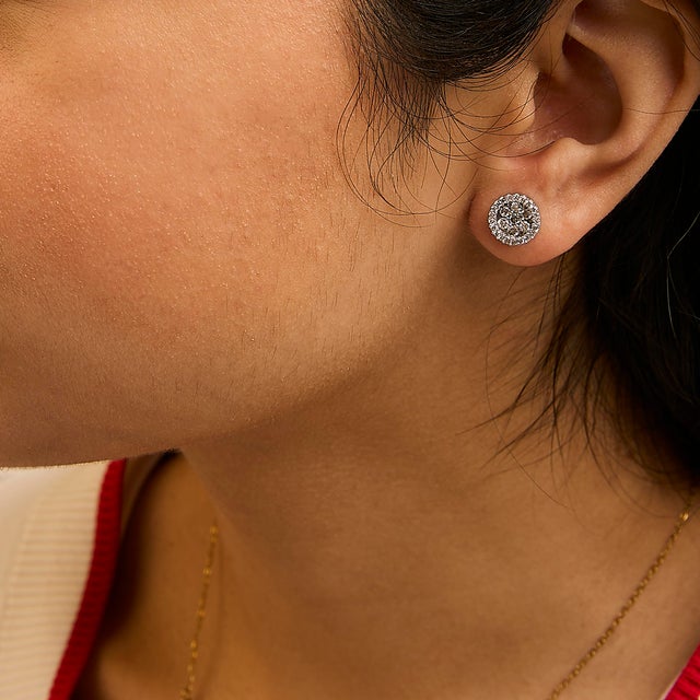 Elegant and timeless, these 14K white gold stud earrings feature round, brilliant cut diamonds in a halo style button...