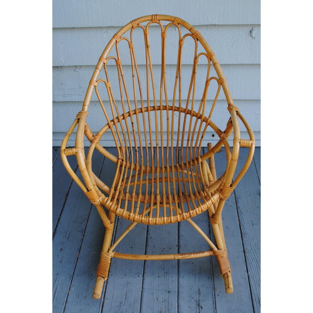 This vintage 1960's fan back bamboo rocking chair is a size for a small space or small adult. It comes with a cute hand...