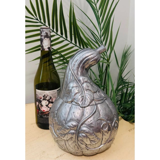 This is a unique, embossed metal squash form art nouveau style ice bucket wine cooler. Adorned with intricate motifs of...