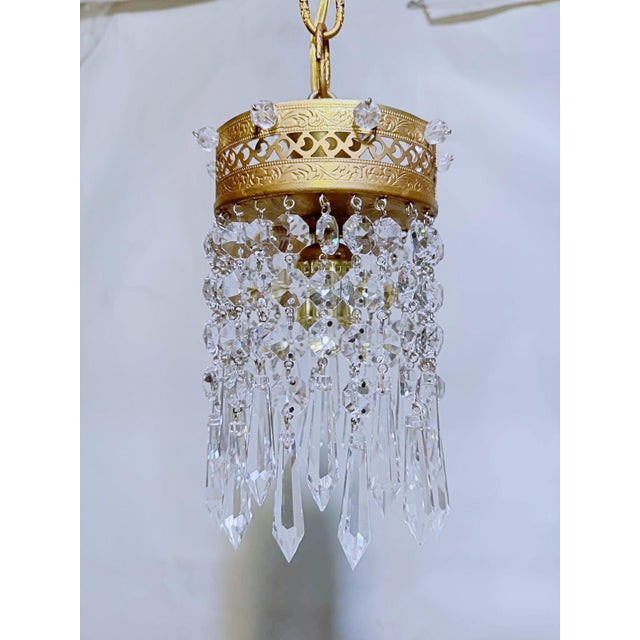 Bring a touch of old-world glamour to your space with this exquisite vintage crystal pendant chandelier. Featuring an...