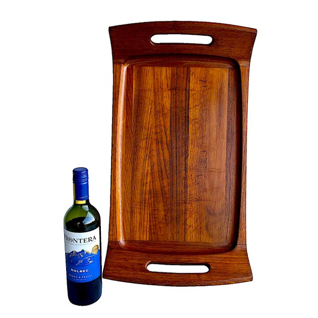 Offered is an extra long Dansk teak wood tray/carving/charcuterie board with sloped handles designed by Jens H....