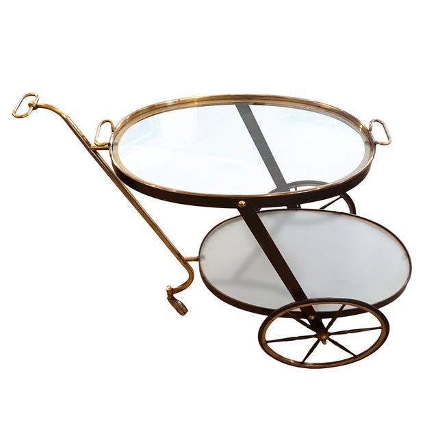 This lovely little drinks trolley was made in Italy in the 1950s. Made from brass and metal, the top shelf is clear glass...