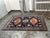 Design Plus Gallery presents a 6ft 6in × 9ft 1in Hand-Knotted Wool Tribal Area Rug. The rug showcases a navy field with...