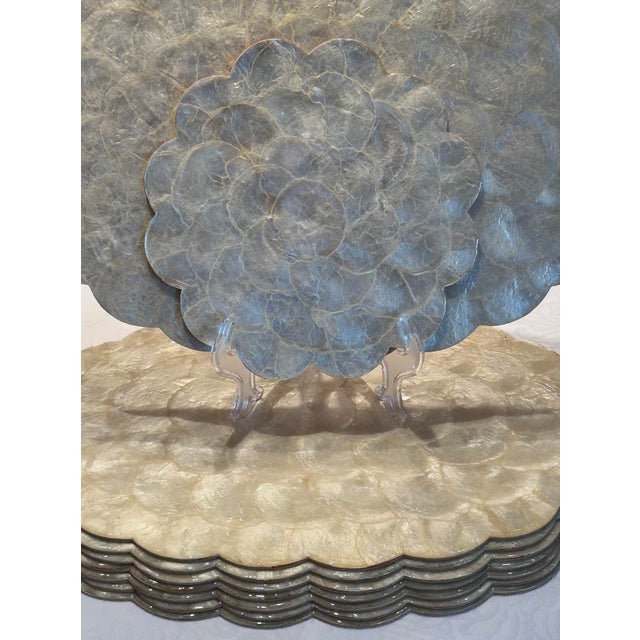 A rare find of a set of 8 scalloped capiz and mother of pearl oval placemats made in the Philippines for Hallie St. Mary....