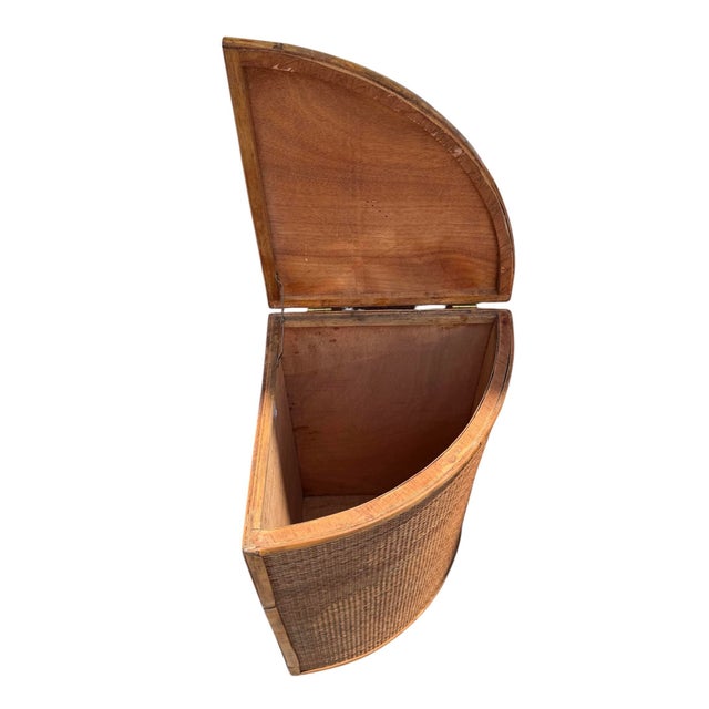 Vintage tortoise rattan corner laundry basket that features a hinged lid and a space-saving triangular design