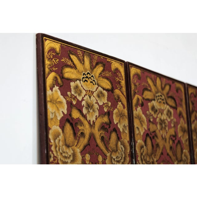 This four-panel Chinese screen presents a striking composition of hand-painted floral and foliate motifs in a warm palette...