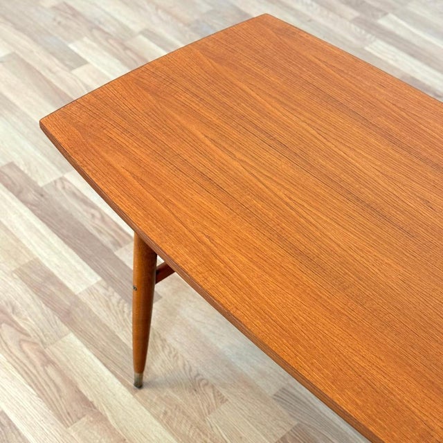 Coffee table was manufactured in Sweden in the 1950s-60s. It is made of teak veneer on the top surface and solid beech...