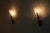 Elegant pair of italian wall lamps from the 1960s, combining sculptural brass fittings with softly curved, translucent...