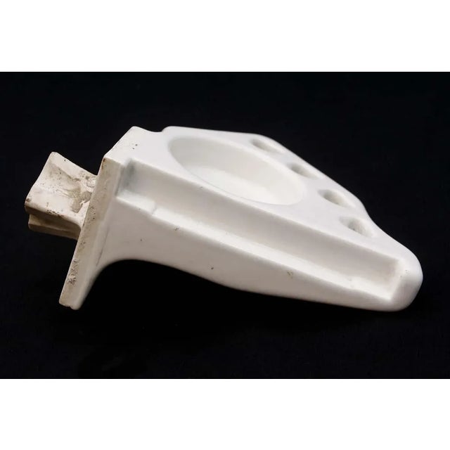 Crafted in white porcelain over ceramic, this flush mount cup and tooth brush holder is of a corner design made to...