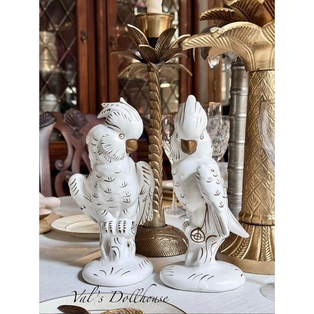 Quintessentially mid-century modern, here is a pair of vintage white cockatoo figures with antique gold accents suitable...