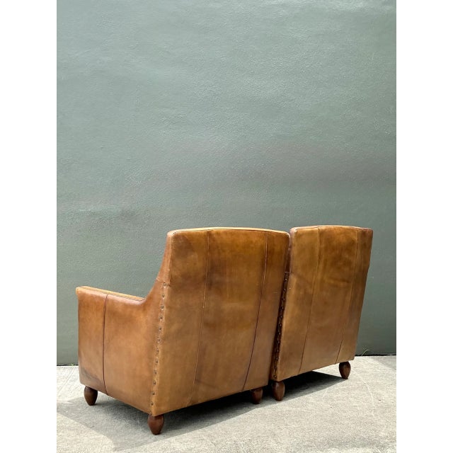 Exuding distinguished warmth and classic European club sophistication, this pair of vintage leather armchairs brings...