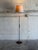 This floor lamp features a sleek metal column paired with rich rosewood accents and a matching circular base. Its refined...