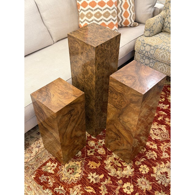 Design Plus Gallery presents a Set of Three Burl Wood Veneer Pedestal/Display Stands. The type of pedestal is attributed...