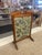 This likely early 20th-century fire screen is a charming example of Arts and Crafts craftsmanship, combining utility with...